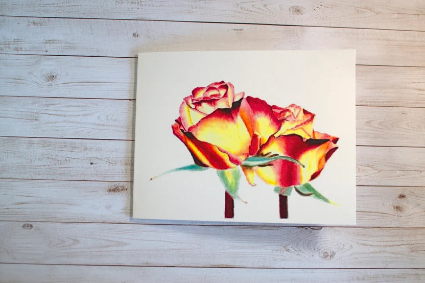 Greeting card with red, yellow, and orange rose artwork on a white card